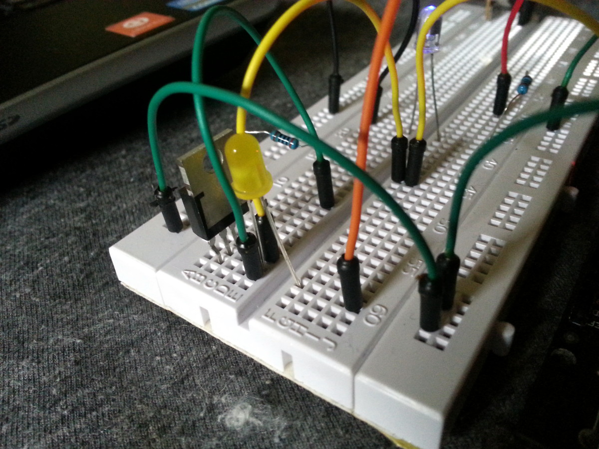 The yellow LED is powered through a MOSFET